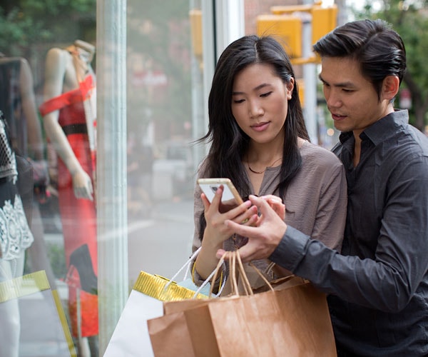 couple looking at phone while shopping