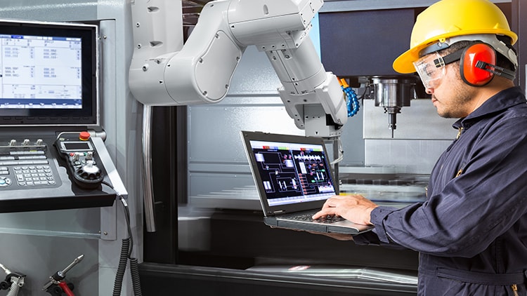 Guy working on machine wearing helmet